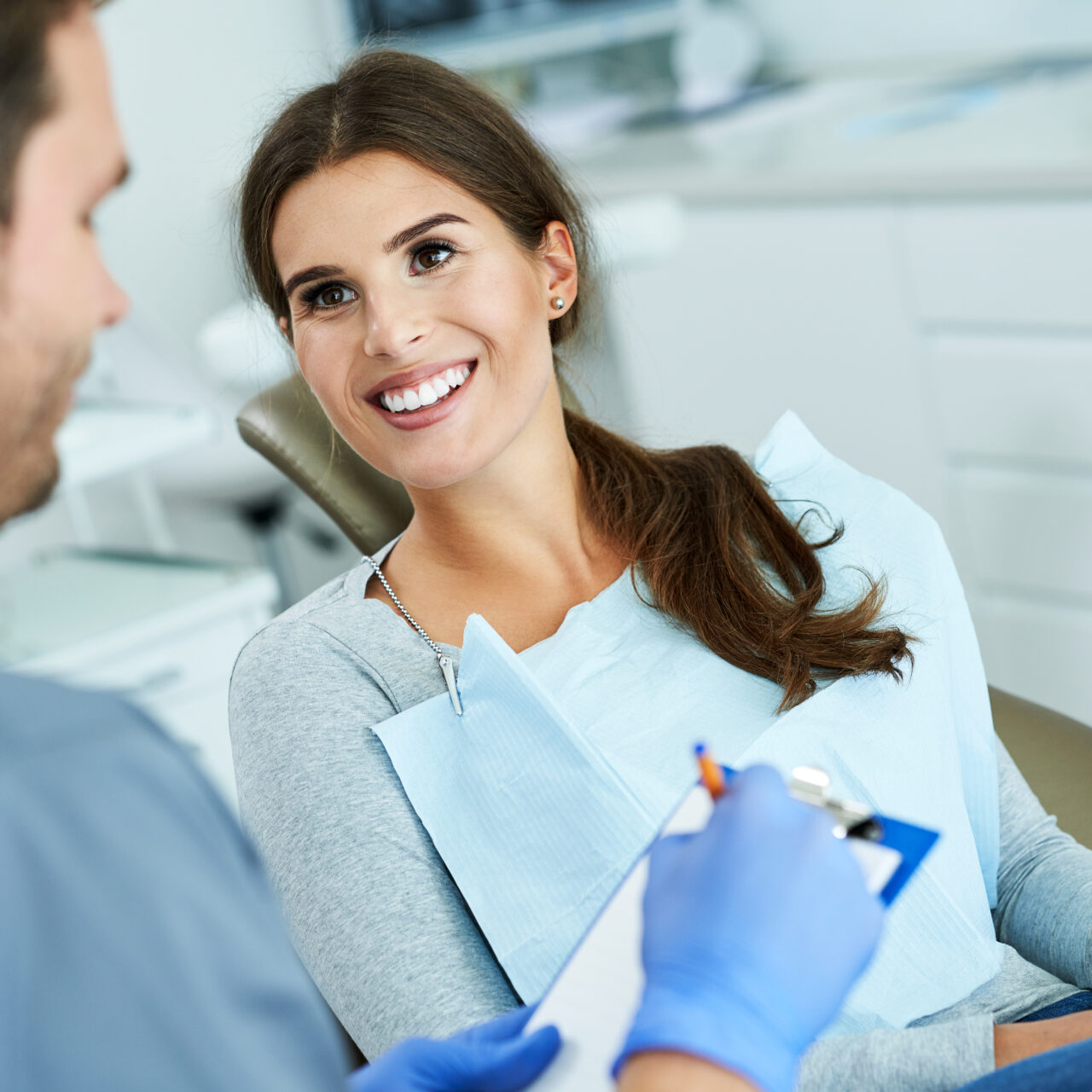 Male dentist and woman in dental clinic